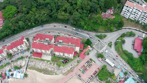 Penang Island , Penang / Malaysia - 12 14 2019: Aerial view of Jalan Batu Ferringhi seafront boulevard with condominiums and car traffic
