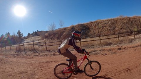 Colorado Springs , Colorado / United States - 01 14 2020: Guy jumps a dirt hill on a trail bike
