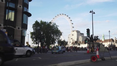 London / United Kingdom (UK) - 07 15 2019: People and cars under London Eye, static view