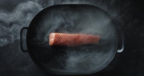 Salmon In A Pan With A Bit Of Water, Fire Smoked Fresh Raw Red Fish Salmon, Video Shot in 4K Resolution