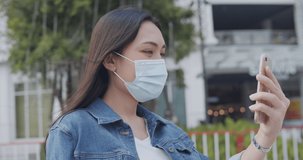 Portrait a young women wearing face mask that protects against the spread of coronavirus or covid-19.Close up Asian female using mobile phones for video call with friend.Slow motion resolution 4k.
