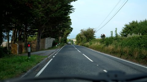 Car dashboard view driving country road B3157 near Swyre in Dorset, United Kingdom.