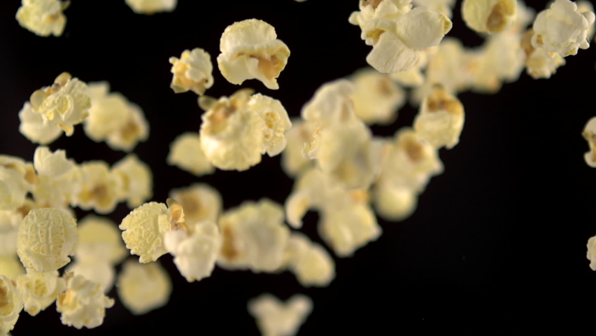 Pop corn flying up in 1000 close up slow motion with dark background | Shutterstock HD Video #1062110128