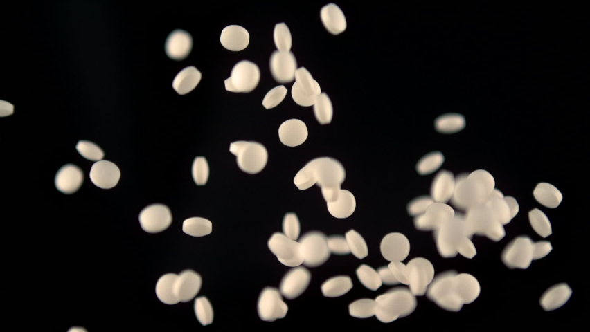 Drug medication pills flying up in 1000fps high speed slow motion with dark background | Shutterstock HD Video #1062110152