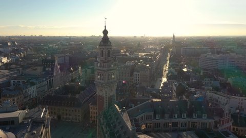 France, North, Lille, drone aerial view above the Général De Gaulle Grand-Place during sunset (or sunrise), belfry of the chamber of commerce in foreground