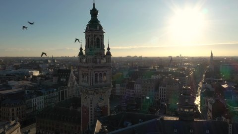 France, North, Lille, wide drone aerial view above the Général De Gaulle Grand-Place during sunset (or sunrise), belfry of the chamber of commerce in foreground