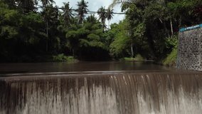 4K Video from drone of an old water dam for water supply of rice fields  in Indonesia