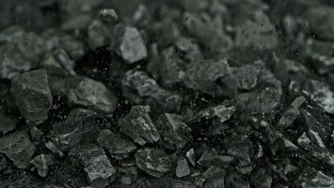 Super Slow Motion Shot of Falling Coal and Black Powder at 1000 fps.