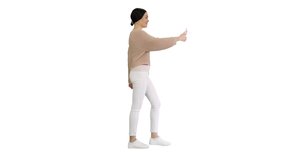 Smiling and gesturing young woman having video call on her phone while walking on white background.
