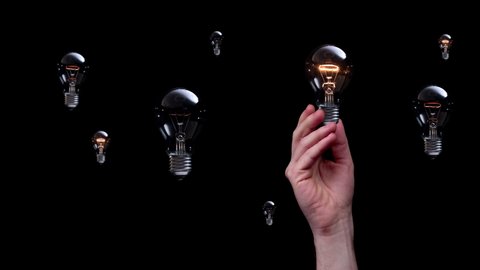 Taking idea from creative universe. Bunch of light bulbs hovers and shines on black background. New idea concept. 