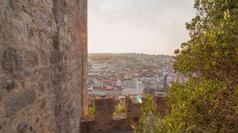 Time lapse of panoramic view of lisbon or lisboa during a sunny cloudy day from the Saint Jeorge castle . There is the capital or portugal in close up with tagus or tago river in background