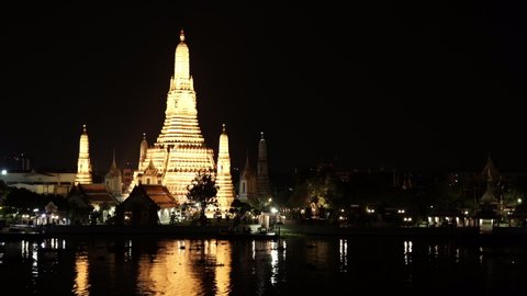 Wat Arun Temple with Chao Phraya river at night in Bangkok, Thailand