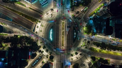 Aerial Hyperlapse view above traffic at a roundabout, at night, in Mexico city, America - Top down, time lapse, drone shot nocturnal