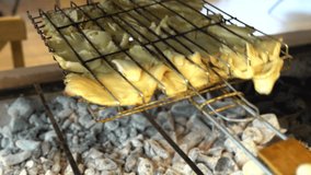 Grilling oyster mushrooms. Slices of brown king oyster mushrooms, being cooked on char grill. Video