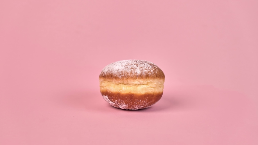 Stop motion sweet doughnut with filling. Half-eaten food., in the context of. On a pink background. Royalty-Free Stock Footage #1062126145