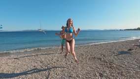 Jumping rope at the beach. Girl in bikini and her friends having fun while jumping rope outdoors on a sunny day. - Powered by Shutterstock - Get 15% off with code: PIKWIZARD15