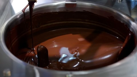 The process of making chocolate confectionery. the mixer mixes the chocolate mass in the confectionery factory