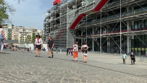 PARIS - AUGUST 22, 2019: Time lapse footage of people walking in front of famous contemporary art museum called "Centre Pompidou" in Paris. It is a sunny summer day.