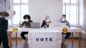 People with face masks voting in polling place, usa elections and coronavirus. - Powered by Shutterstock - Get 15% off with code: PIKWIZARD15