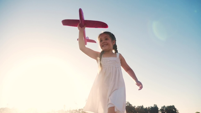 happy girl child run with an airplane. kid silhouette play plane. happy family dream freedom airplane concept. daughter kid run on wheat field at sunset holds in his hands dream fun aircraft toy Royalty-Free Stock Footage #1062134323