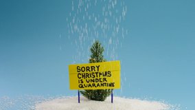 Pine tree and sign board with message Sorry Christmas is under quarantine - Powered by Shutterstock - Get 15% off with code: PIKWIZARD15