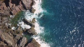 The blue waters on the ocean in Tenerife Spain as seen on an aerial shot of the rocky shore