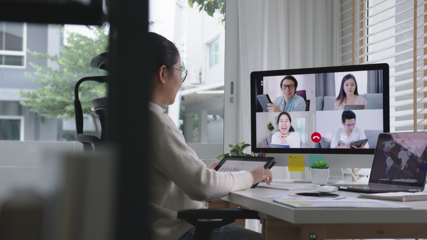 Tracking : business woman talking about sale report in video conference.Asian team using laptop and tablet online meeting in video call.Working from home, Working remotely and Self isolation at home Royalty-Free Stock Footage #1062141328