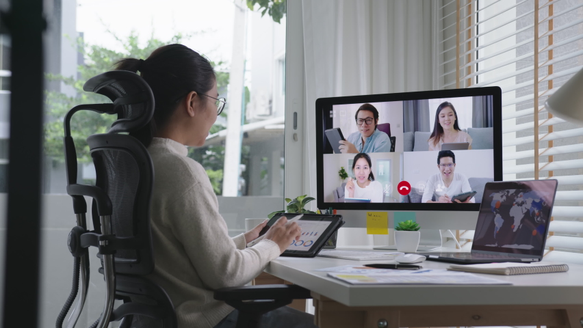 Tracking : business woman talking about sale report in video conference.Asian team using laptop and tablet online meeting in video call.Working from home, Working remotely and Self isolation at home Royalty-Free Stock Footage #1062141328