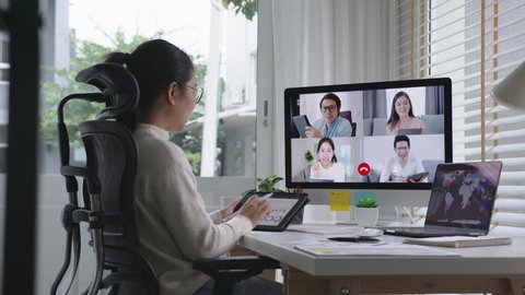 Tracking : business woman talking about sale report in video conference.Asian team using laptop and tablet online meeting in video call.Working from home, Working remotely and Self isolation at home