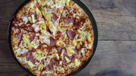 Rotating Hawaiian Pizza with Ham and Pineapple