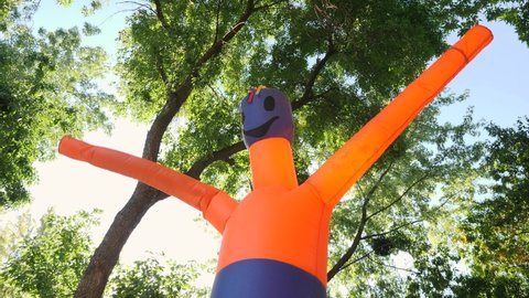 Wacky Waving Inflatable Tube Man. Inflatable Orange Wacky Dancer Tube Man Flailing Arms Invites to the City Park for a Holiday Halloween. Air Generic Advertising Sign. Entertainment Outdoors