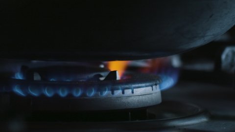 Gas stove is lit followed by a pan being placed above. Ideal for cooking shows, vlogs, cinematic films and more. In stunning 4K.