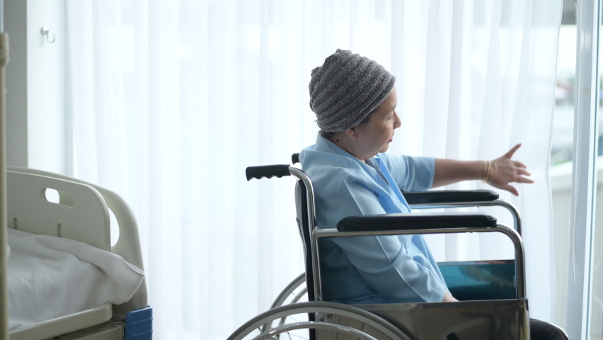 Depressed and hopeless Asian cancer patient woman wearing head scarf in hospital.	
 | Shutterstock HD Video #1062148429
