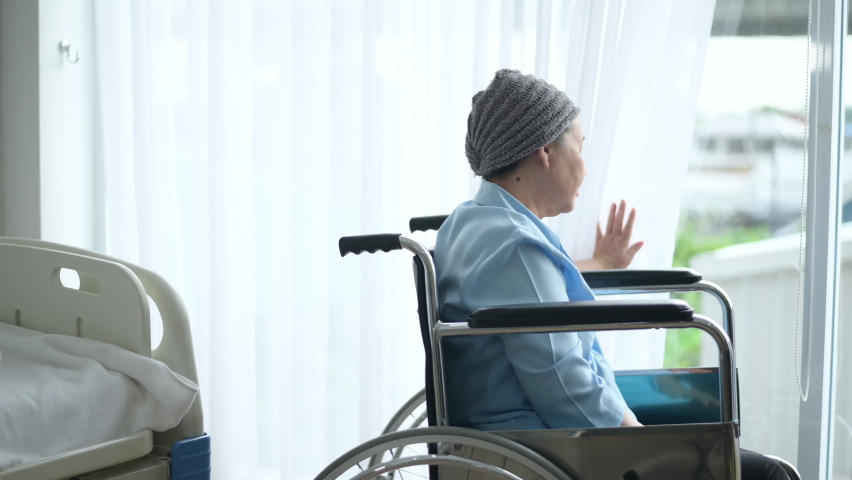 Depressed and hopeless Asian cancer patient woman wearing head scarf in hospital.	
 | Shutterstock HD Video #1062148429
