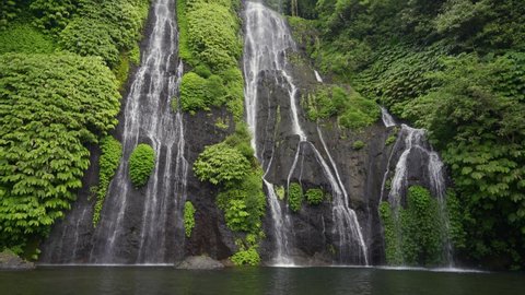 Amazing waterfall hidden in tropical rainforest. Beautiful nature background. 4K