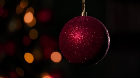 Christmas background.  Ball in abstract decoration lights, multicolored sparkles, shine blurred background. Copy space.  