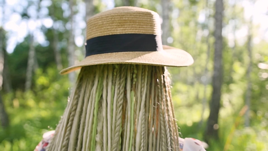 portrait of a happy girl who walks in the summer forest in the morning sun