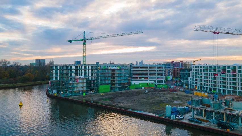 Amsterdam, 9th of November 2020, The Netherlands Aerial hyperlapse of a construction site at the Cruquiuswerf Amsterdam East, Buildings with cranes