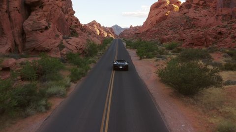 Nevada / United States - 05 24 2019: Black Ferrari convertible speeding through the canyons of the Valley of Fire