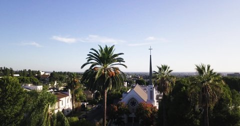 Whittier , California / United States - 10 19 2019: First United Methodist Church. Aerial view of the Whittier, drone dolly in shot between the trees