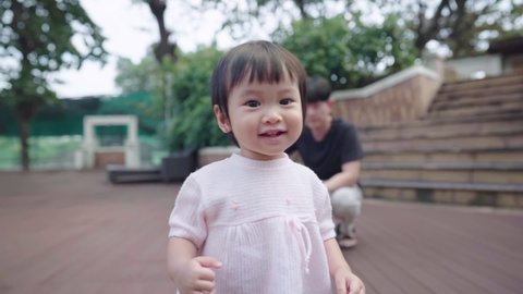 Asian small child feeling happy smiling while walking by inside park, family youngest member, toddler taking first step walk, beginning of new life, innocence little girl learn how to walk, joyful kid Video stock