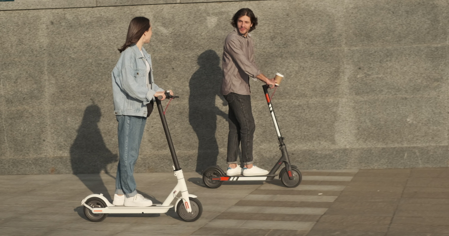 Couple using electric scooter in city Royalty-Free Stock Footage #1062158713