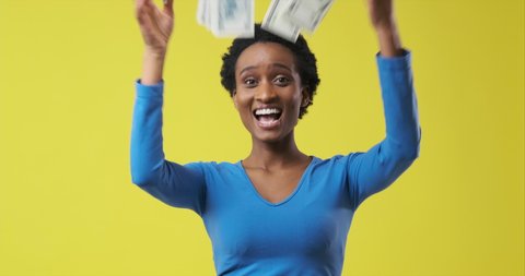 Happy woman throwing out cash dollars