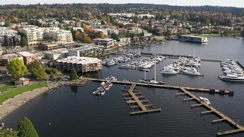Aerial / drone footage of Kirkland downtown, park and beach, City Dock, Moss Bay commercial and residential suburban neighborhood near Bellevue and Seattle, King County, Pacific Northwest Washington