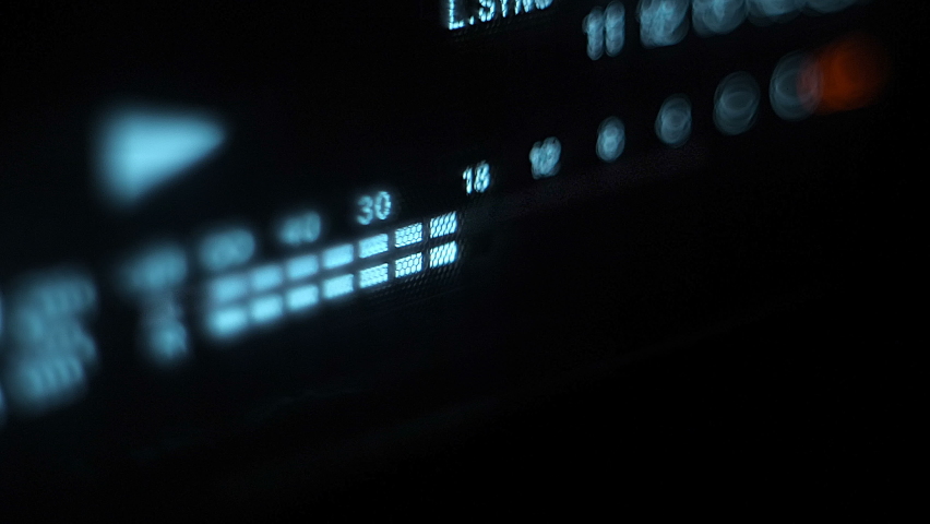 Glowing blue stereo level recording music, speech, other sound on the front panel of audio equipment, on a black background. Closeup Royalty-Free Stock Footage #1062165703