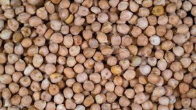 Scattered Turkish chickpeas are rotated on the table. High protein legumes,beans and lentils for healthy food.