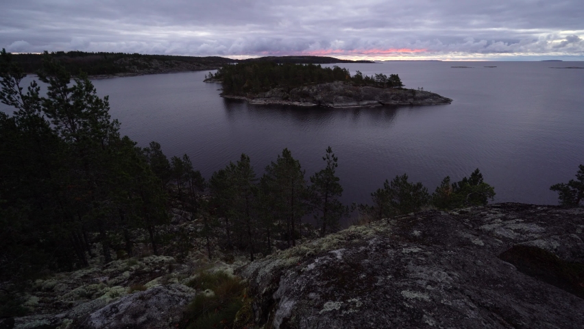 Cloudy sunrise on lake Ladoga and skerries in Russian Karelia in Northern Russia.