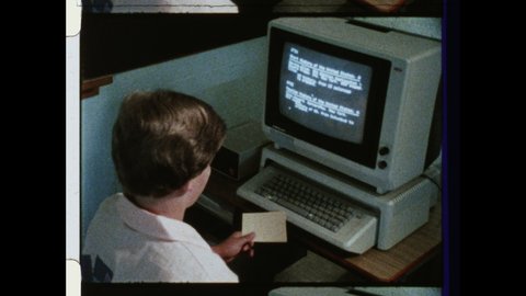 1980s Cupertino, CA Young Man works on Apple II Desktop Computer. 4K Overscan of 16mm FilmPrint