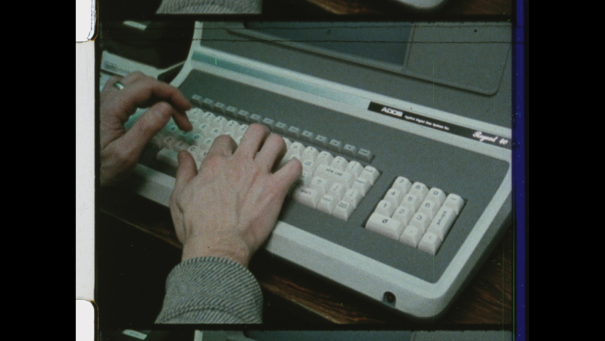 1980s Cupertino, CA Close Up of Hands typing on computer keyboard. Man types on a vintage computer. 4K Overscan of 16mm Film Print