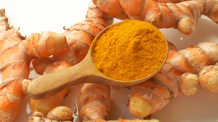 Turmeric and Turmeric powder in a wooden spoon Rotation Royalty-Free Stock Footage #1062176377